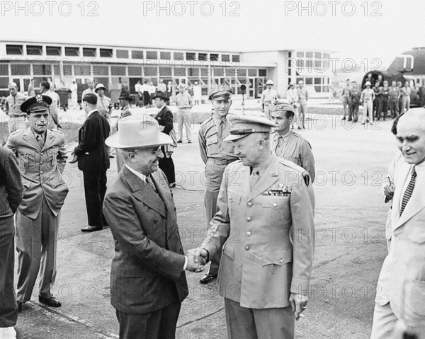 U.S. President Harry S. Truman (left) shaking hands with U.S. General Dwight Eisenhower (right), National Airport, National Airport, Washington, D.C., USA, Abbie Rowe, National Parks Service, Harry S. Truman Library, June 19, 1945