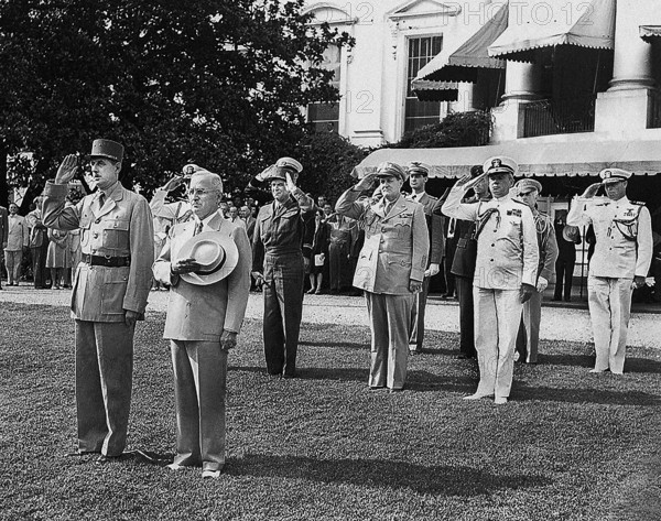 U.S. President Harry S. Truman, right, and Charles De Gaulle, Chairman of the Provisional Government of the French Republic, left, stand at attention during the welcoming ceremonies for the French visit to the White House, Washington, D.C., USA, Abbie Rowe, National Parks Service, Harry S. Truman Library, August 22, 1945