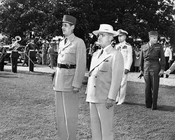 U.S. President Harry S. Truman, right, and Charles De Gaulle, Chairman of the Provisional Government of the French Republic, left, stand at attention during the welcoming ceremonies for the French visit to the White House, Washington, D.C., USA, Abbie Rowe, National Parks Service, Harry S. Truman Library, August 22, 1945