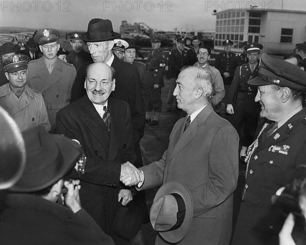 British Prime Minister Clement Attlee (foreground, third from right) shaking hands with U.S. Secretary of State James Byrnes (foreground, second from right) upon arrival, National Airport, Washington, D.C., USA, Abbie Rowe, National Parks Service, Harry S. Truman Library, November 10, 1945