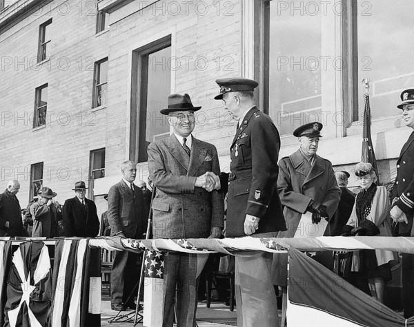 U.S. President Harry S. Truman (right center) shaking hands with retiring U.S. Army Chief of Staff General George C. Marshall (left center) after awarding him with an Oak Leaf Cluster to his Distinguished Service Medal in the Pentagon Court, Arlington, Virginia, USA, Abbie Rowe, National Parks Service, Harry S. Truman Library, November 26, 1945