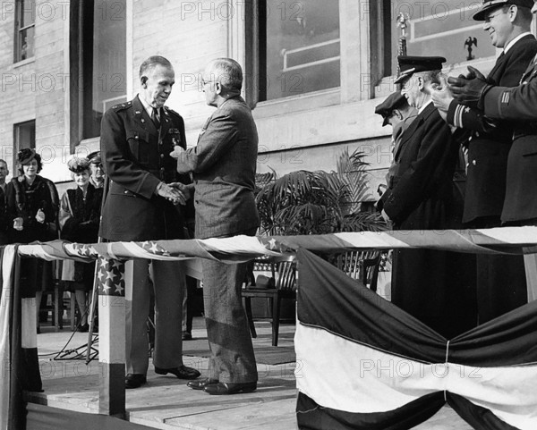 U.S. President Harry S. Truman (right center) shaking hands with retiring U.S. Army Chief of Staff General George C. Marshall (left center) and presenting him with an Oak Leaf Cluster to his Distinguished Service Medal in the Pentagon Court, Arlington, Virginia, USA, Abbie Rowe, National Parks Service, Harry S. Truman Library, November 26, 1945