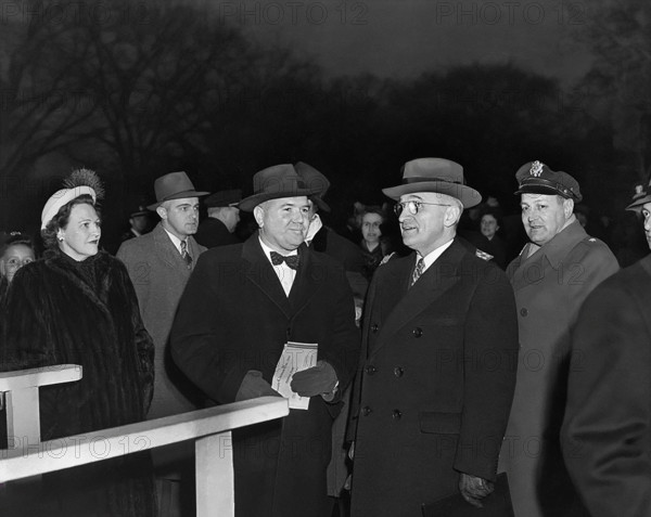 U.S. President Harry S. Truman (second from right) at lighting of the National Community Christmas Tree on White House grounds, flanked by several unidentified people and U.S. General Harry Vaughan, his Military Aide (behind the President's left shoulder), Washington, D.C., USA, Abbie Rowe, National Parks Service, Harry S. Truman Library, December 24, 1945