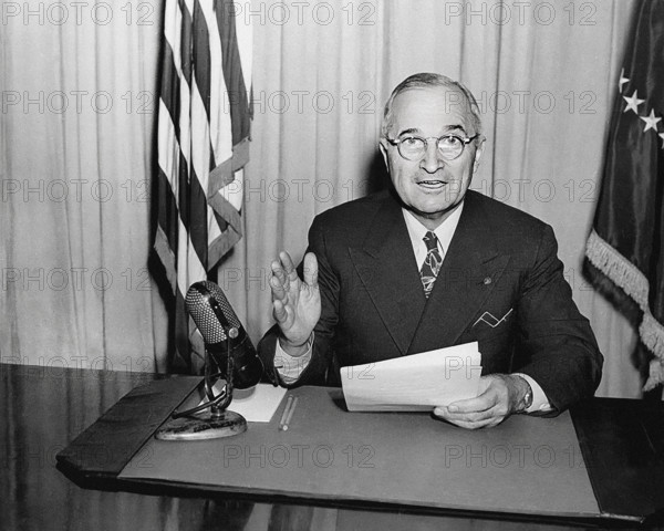 U.S. President Harry S. Truman delivering radio speech to the nation concerning the reconversion program for a peacetime economy, White House Oval Office, Washington, D.C., USA, Abbie Rowe, National Parks Service, Harry S. Truman Library, January 3, 1946