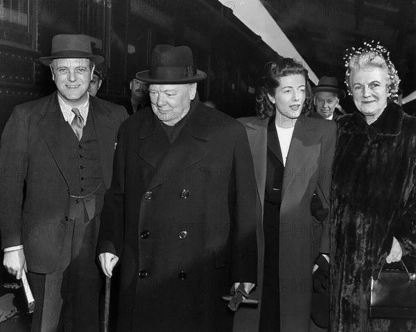 Former British Prime Minister Winston Churchill (second from left) with his wife Clementine Churchill (right), shortly after his arrival in the United States, Abbie Rowe, National Parks Service, Harry S. Truman Library, February 10, 1946