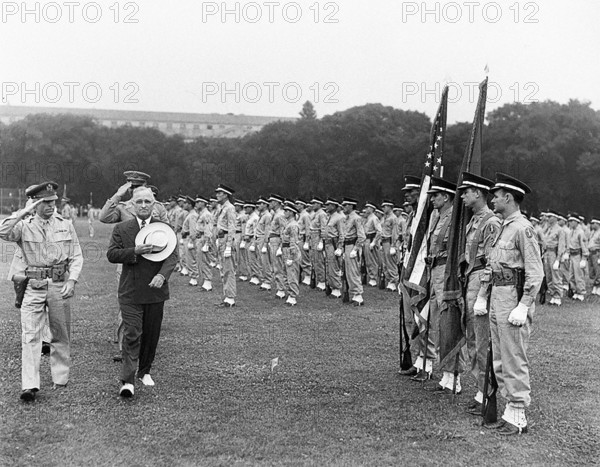 U.S. President Harry S. Truman (in civilian suit and hat) and military officers saluting as they walk past color guard during President's review of District of Columbia military police on the Ellipse, Washington, D.C., USA, Abbie Rowe, National Parks Service, Harry S. Truman Library, July 9, 1946
