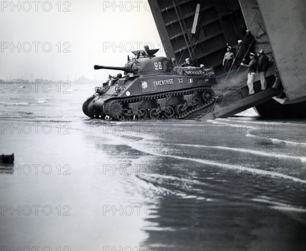 Sherman tanks, manned by French armored troops, rolling down landing ship ramp onto Utah beach, Normandy, France, U.S. Army Signal Corps, August 2, 1944