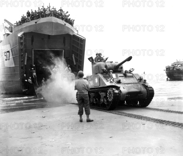 Sherman tanks, manned by French armored troops, rolling out from landing ship ramp onto Utah beach, Normandy, France, U.S. Army Signal Corps, August 2, 1944
