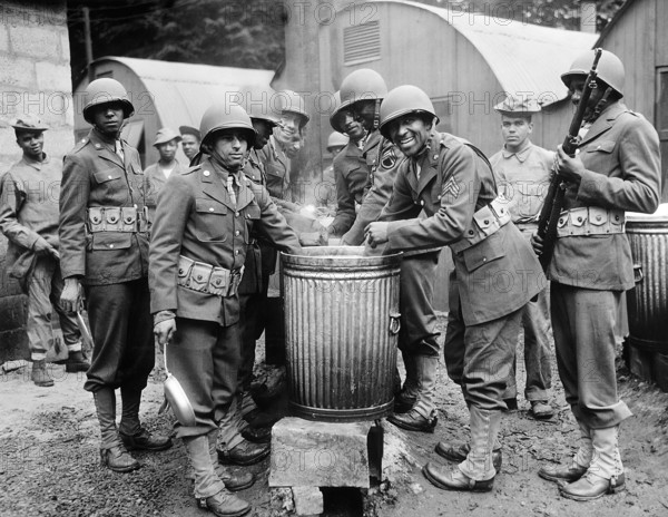 African American soldiers drawing rations at camp cook house, Northern Ireland, U.S. Office of War Information, August 1942