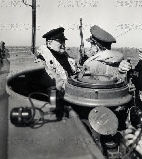 Prime Minister Winston Churchill of Great Britain, left, chatting with British General Sir Alan Brooke, right, Chief of the Imperial General Staff on warship carrying them to British General Sir Bernard Montgomery's temporary headquarters in France, U.S. Army Signal Corps, June 12, 1944