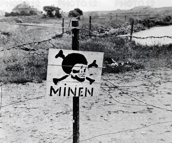 Abandoned German minefield surrounded by barbed wire discovered by advancing U.S. Army troops, Normandy, France, U.S. Army Signal Corps, June 11, 1944