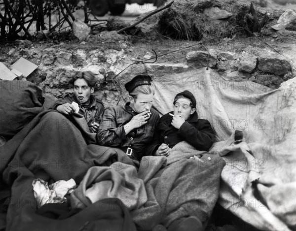 British crew members of an LST having their first night of decent rest after having been brought to shore in smaller landing craft, Omaha Beach, Normandy, France, U.S. Army Signal Corps, June 21, 1944