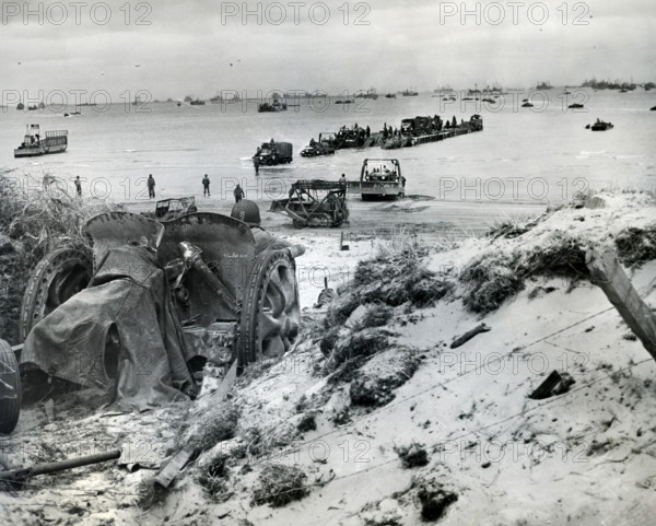 Vehicles of 1st Army Corps being unloaded onto Utah Beach from barge, La Madeleine, Normandy, France, U.S. Army Signal Corps, June 6, 1944