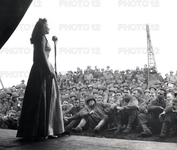 USO singer entertaining American troops of 7th Armored Division, Geldrop, Netherlands, U.S. Army Signal Corps, October 16, 1944