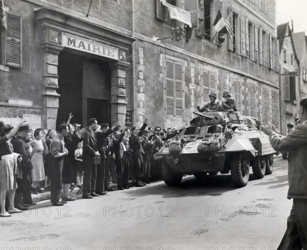 U.S. Major General Lindsay McDonald Silvester, 7th Armored Division, receiving cheers from French citizens after town was taken by American tanks and infantry, Chartres, France, U.S. Army Signal Corps, August 16, 1944