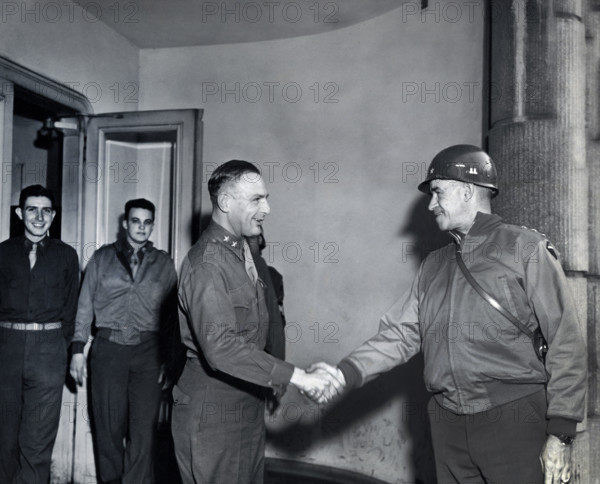 U.S. Lieutenant General Omar N. Bradley (right), 12th Army Group, shaking hands with U.S. Major General Robert W. Hasbrouck, 7th Armored Division, during General Bradley's tour of U.S. First Army Divisions, Eupen, Belgium, Cutler, U.S. Army Signal Corps, February 19, 1945