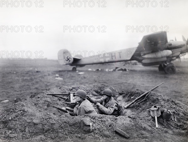 U.S. G.I.'s watching for enemy activity from their outpost at German airfield captured by U.S. Ninth Armored Division, U.S. First Army, Fritzlar, Hesse, Germany, U.S. Army Signal Corps, April 1, 1945