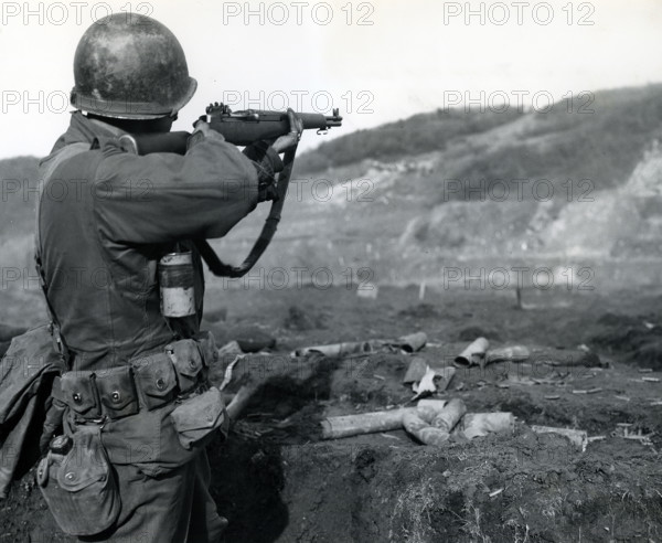 U.S. Sargeant Gzurec of Ely, Minnesota, Company D, 18th Regiment, 1st Infantry Division, U.S. First Army, practicing with his M-1 rifle at a range near Vicht, North Rhine-Westphalia, Germany, U.S. Army Signal Corps, February 21, 1945