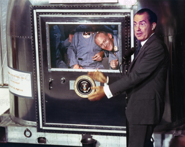 U.S. President Richard Nixon greeting Apollo 11 astronauts Neil A. Armstrong, Edwin E. Aldrin and Michael Collins, inside quarantine facility after successful recovery mission, USS Hornet, NASA, July 24, 1969