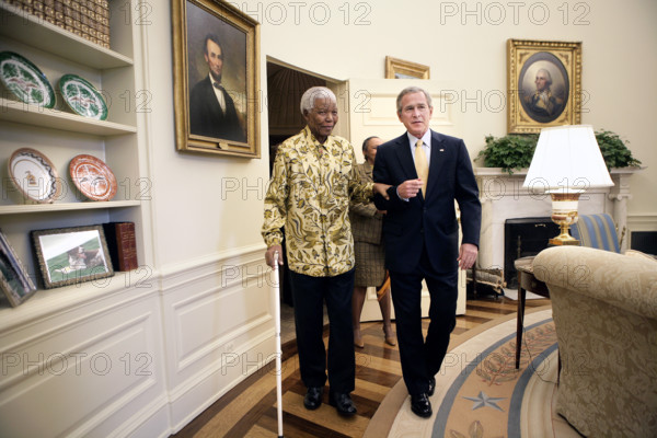 U.S. President George W. Bush and Former President Nelson Mandela of South Africa meet in White House Oval Office, Washington, D.C., USA, Eric Draper, George W. Bush White House Photo Office, May 17, 2005