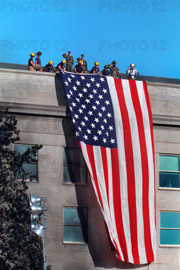 Firefighters hanging large American flag from roof of Pentagon near crash site of American Airlines Flight 77, Arlington County, Virginia, USA, Paul Morse, George W. Bush White House Photo Office, September 12, 2001