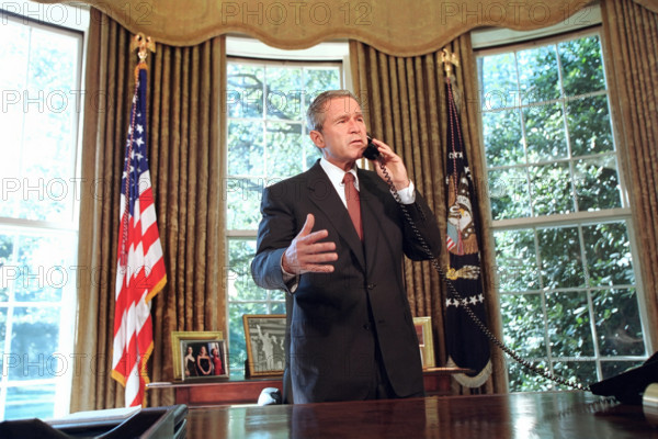 U.S. President George W. Bush talking on telephone with New York Governor George Pataki and New York City Mayor Rudolph Giuliani, White House Oval Office, Washington, D.C., USA, Paul Morse, George W. Bush White House Photo Office, September 13, 2001