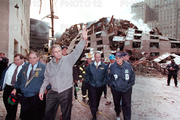 U.S. President George W. Bush waving while touring 7 World Trade Center disaster site with (from left) New York Congressman Jerrold Nadler, Director of New York City’s Office of Emergency Management Richard J. Sheirer, U.S. from New York Senator Hillary Rodham Clinton, New York Governor George Pataki, New York Fire Department Commissioner Thomas Von Essen, U.S. Senator from New York Chuck Schumer, New York City Mayor Rudolph Giuliani and Chief of Staff Joe Hagin, Financial District, Manhattan, New York City, New York, USA, Paul Morse, George W. Bush White House Photo Office, September 14, 2001