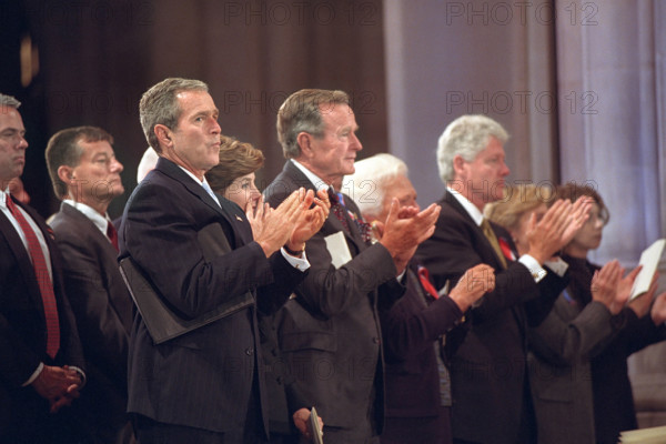U.S. President George W. Bush, U.S. First Lady Laura Bush, former U.S. President George H. W. Bush, Former U.S. First Lady Barbara Bush, former U.S. President Bill Clinton, former U.S. First Lady and U.S. Senator from New York Hillary Rodham Clinton and Chelsea Clinton applauding during National Day of Prayer and Remembrance Service, National Cathedral, Washington, D.C., USA, Eric Draper, George W. Bush White House Photo Office, September 14, 2001