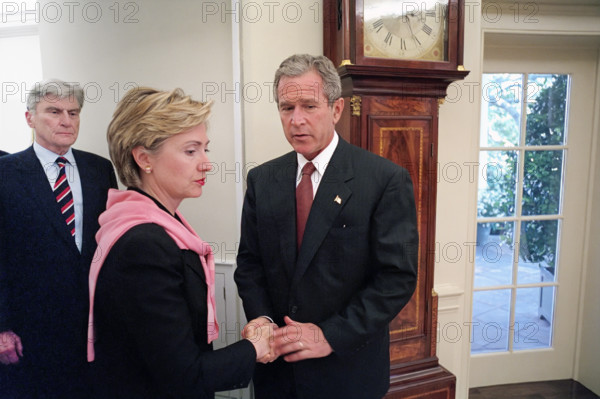 U.S. President George W. Bush shaking hands with U.S. Senator from New York Hillary Rodham Clinton as U.S. Senator from Virginia John Warner looks on, White House Oval Office, Washington D.C., USA, Eric Draper, George W. Bush White House Photo Office, September 13, 2001