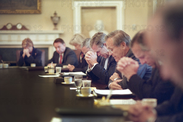 U.S. President George W. Bush bowing his head as U.S. Secretary of Defense Donald Rumsfeld leads prayer before cabinet meeting, White House Cabinet Room, Washington, D.C., USA, Eric Draper, George W. Bush White House Photo Office, September 14, 2001