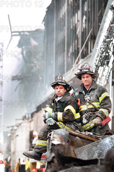 Two firefighters look on during U.S. President George W. Bush's visit to World Trade Center disaster site, Financial District, Manhattan, New York City, New York, USA, Paul Morse, George W. Bush White House Photo Office, September 14, 2001