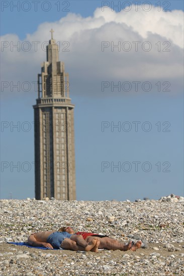 France: Normandie, Seine Maritime, le havre, plage, mer, couple allonge, bronzage, galets, jambes, vacances, loisirs balneaires, clocher eglise saint joseph