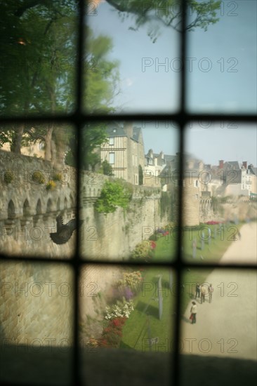 France, Bretagne, Morbihan, Vannes, golfe du Morbihan, depus la tour du connetable au travers d'une fenetre a l'ancienne, vue troublee, pigeon qui s'envole, jardins des remparts,