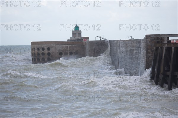 Wave flooding the dyke