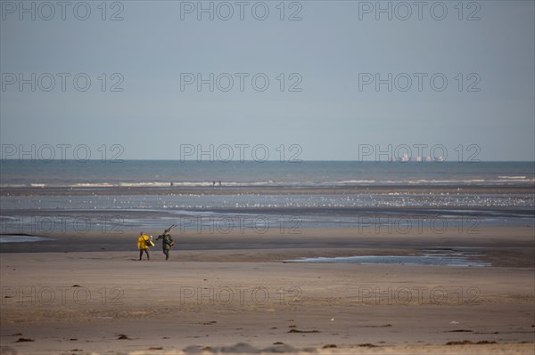 Le Touquet Paris Plage, fishermen in yellow oilskins