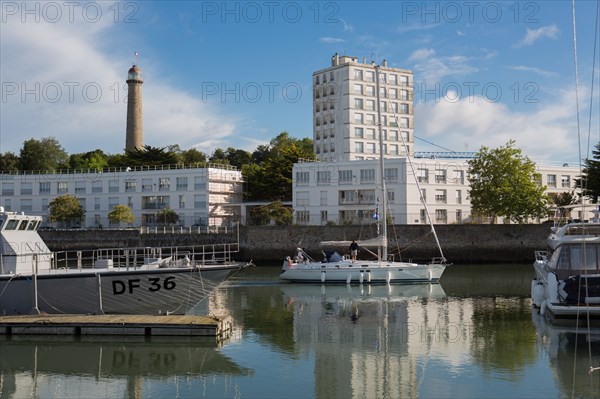 Lorient, port, grey customs boat and sailing boat leaving the port