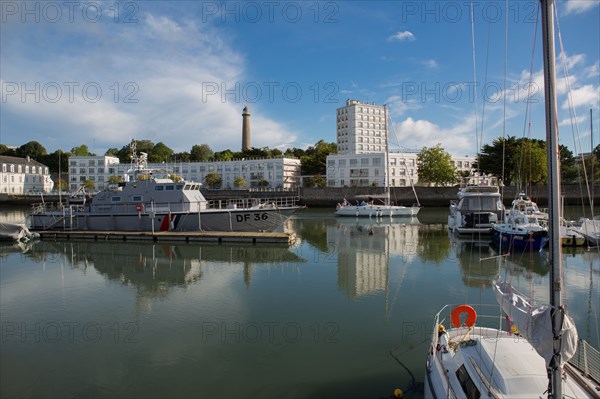 Lorient, port, grey customs boat and sailing boat leaving the port