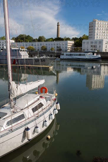 Lorient, port, grey customs boat and sailing boat leaving the port