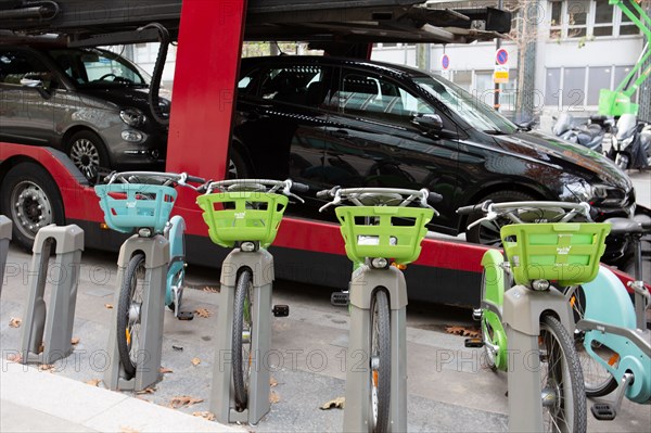 Paris, Vélib' bike and truck with a car carrier trailer