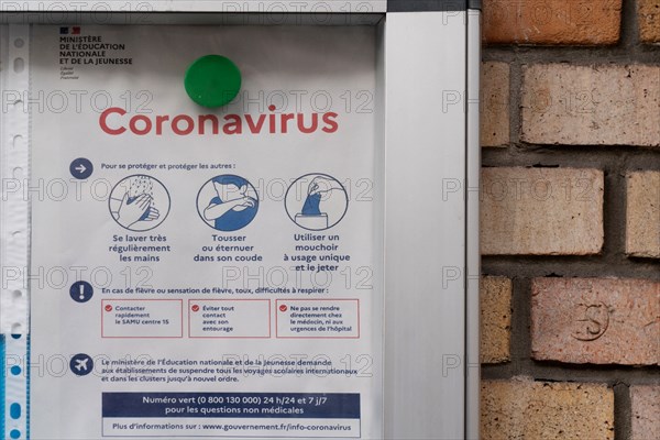 Paris, information panel on coronavirus in front of a school