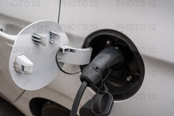 Paris, electric car plugged in a charging station