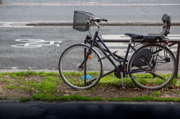 Paris, parked bicycle near a cycle path