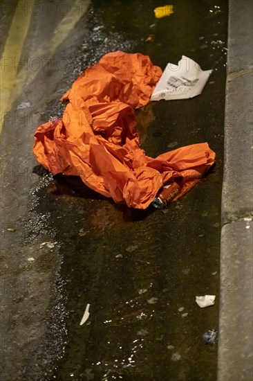 Paris, napkin and can laid in a gutter