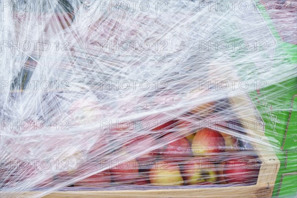 Paris, crate with apples covered with a cellophane