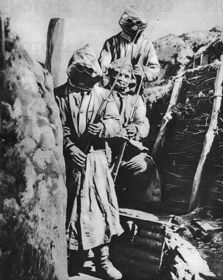 Soldiers in gas masks and protective clothing.