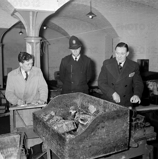 Checking packages at the East India Company Warehouses, Cutler Street, London, c1945-c1965