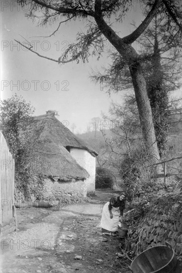 Woman fetching water, Bratton, Minehead, Somerset, c1900