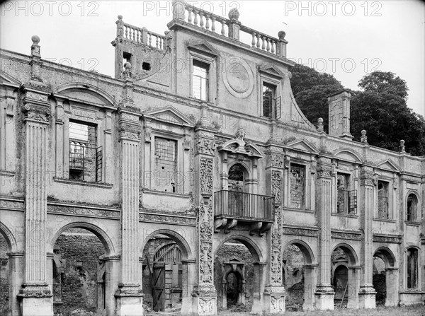 Empty shell of the north side of inner courtyard at Kirby Hall, Gretton, Northamptonshire, 1925.   Artist