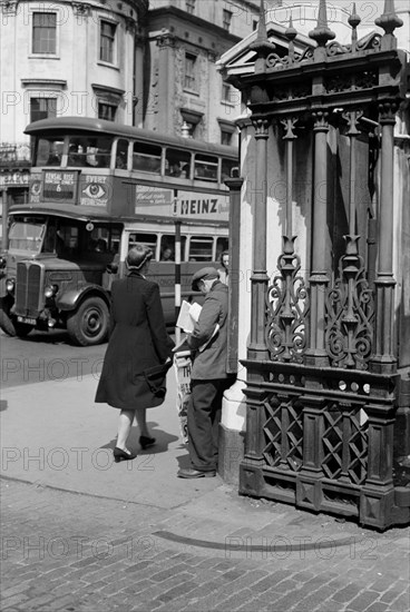 A newspaper seller at Charing Cross Station, London, c1945-c1955