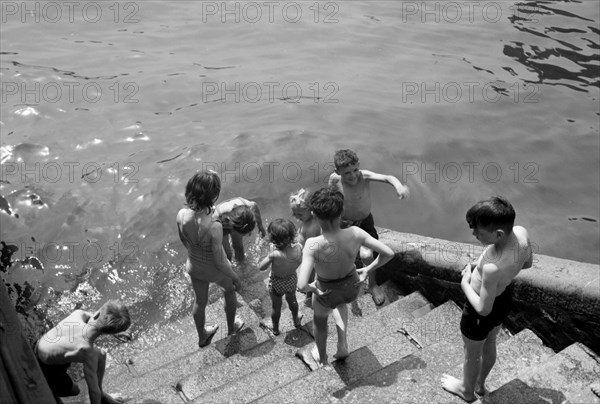 Children bathing in the River Thames, Tower Pier approach, Stepney, London, c1945-c1965